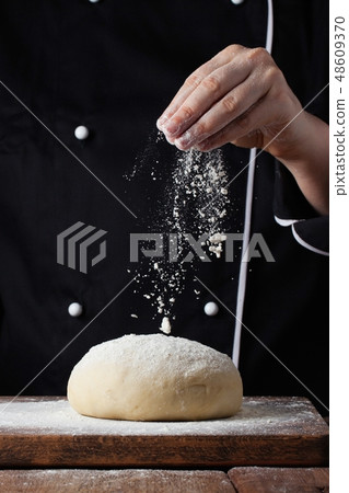 Chef hands pouring flour powder. Chef hands pouring flour powder. 48609370