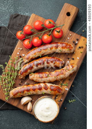 Fried sausages with sauces and herbs. 48609393