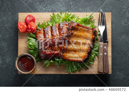 Closeup of pork ribs grilled with BBQ sauce. 48609572