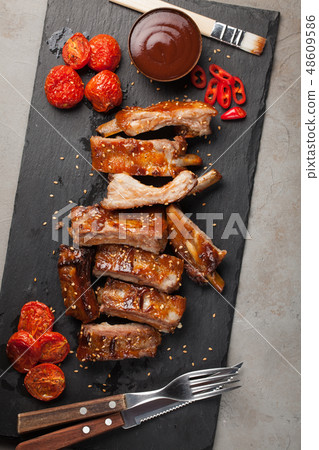 Grilled pork ribs in barbecue sauce. 48609586