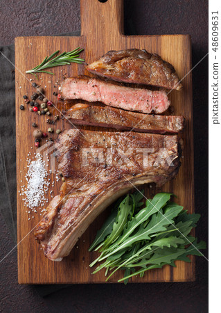Grilled cowboy beef steak. Grilled cowboy beef steak. 48609631