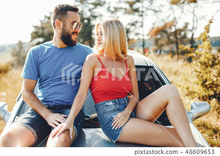 Beautiful couple spend time in a summer park Beautiful couple spend time in a summer park 48609653