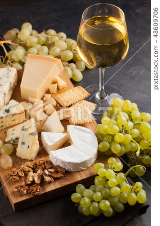 Assorted cheeses with white grapes. 48609706