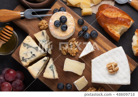 Tasting cheese dish on a dark stone plate. Tasting cheese dish on a dark stone plate. 48609718
