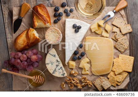 Tasting cheese dish on a wooden background. Tasting cheese dish on a wooden background. 48609736
