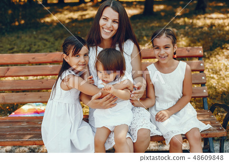 Mother with daughter playing in a summer park Mother with daughter playing in a summer park 48609848