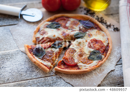 Appetizing pizza margarita on a wooden table. 48609937