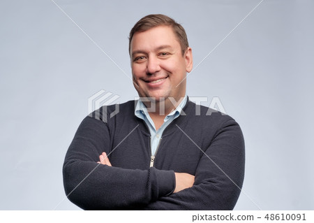 confident middle aged man with folded arms  48610091