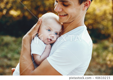 Cute family playing in a summer park Cute family playing in a summer park 48610215