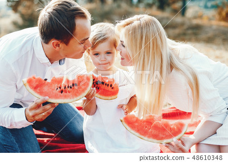 Cute family playing in a summer park 48610348