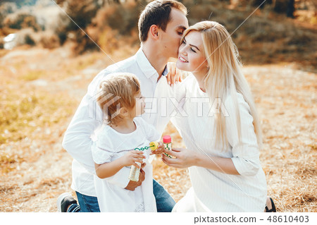 Cute family playing in a summer park Cute family playing in a summer park 48610403