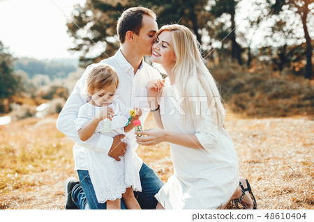 Cute family playing in a summer park Cute family playing in a summer park 48610404