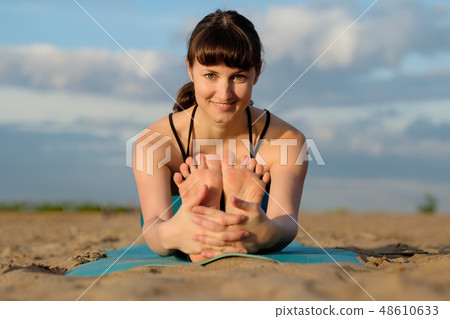 Portrait of sporty young woman practicing yoga Portrait of sporty young woman practicing yoga 48610633