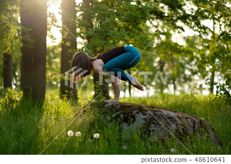 caucasian girl doing yoga in city park. caucasian girl doing yoga in city park. 48610641