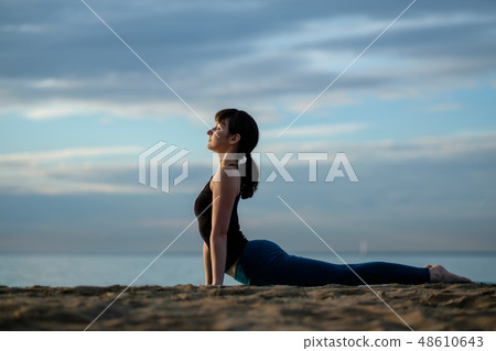 Yoga asana outdoors on beach. Yoga asana outdoors on beach. 48610643