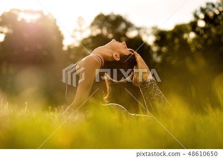 yoga woman on green park 48610650