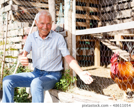 Older man near henhouse 48611054