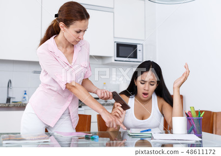 Mother taking away smartphone Mother taking away smartphone 48611172