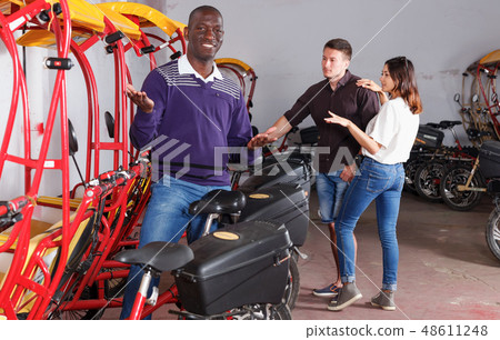 Portrait of smiling African-American man offering cycle rickshaw Portrait of smiling African-American man offering cycle rickshaw 48611248