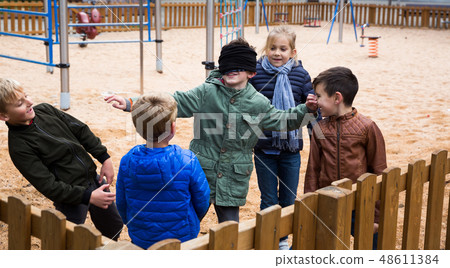Children play in the blind man's buff Children play in the blind man's buff 48611384