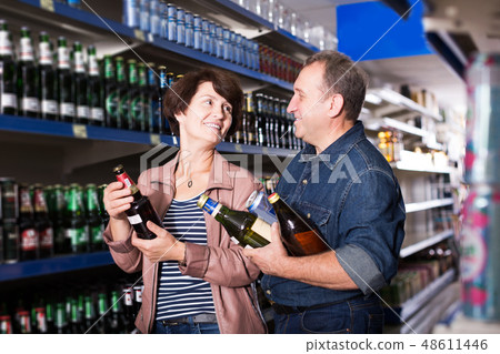Couple shooses beer in store 48611446
