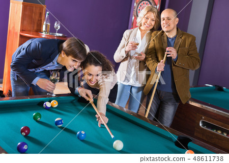 Relaxed friendly people playing billiard and darts 48611738