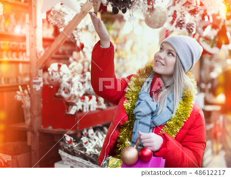 Girl shopping Christmas decorations 48612217