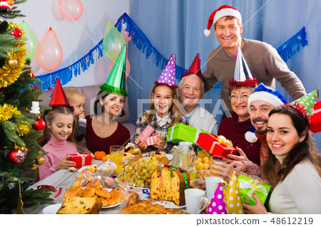 Large family exchanging gifts during Christmas dinner 48612219