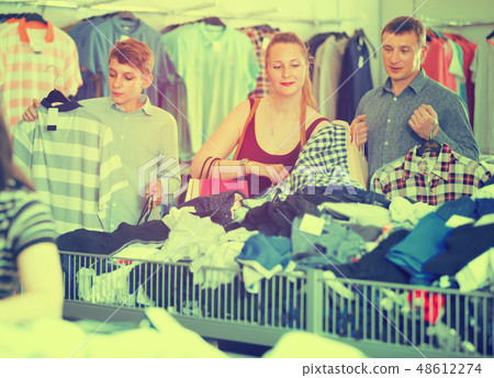 Positive family of three choosing clothes Positive family of three choosing clothes 48612274
