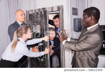 Businesspeople holding door Businesspeople holding door 48612369