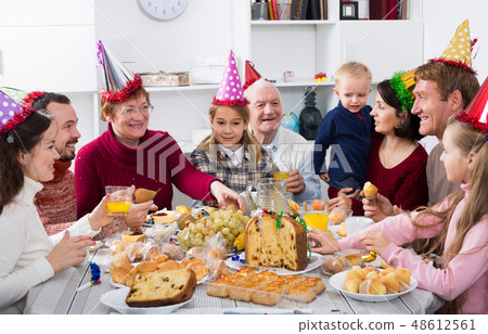 Happy family members saying toasts during dinner 48612561