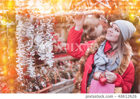 Girl shopping Christmas decorations 48612626