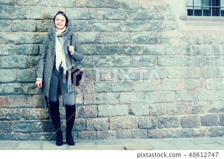 teenager girl in hood near wall teenager girl in hood near wall 48612747