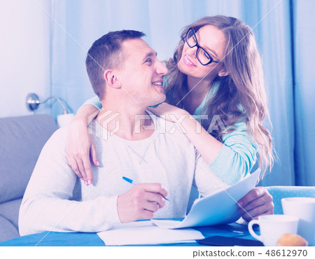 Couple signing papers Couple signing papers 48612970