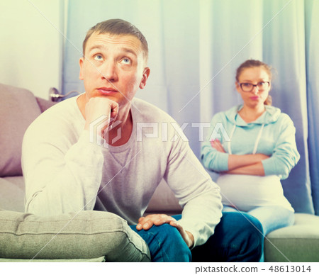 Husband and pregnant wife arguing at home 48613014