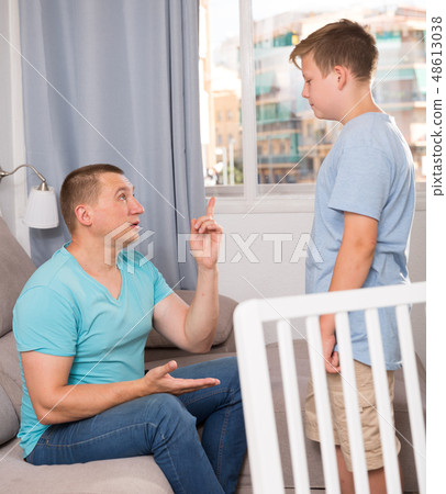 Adult male with his anxious son are resting together and talking about teenage secrets 48613038