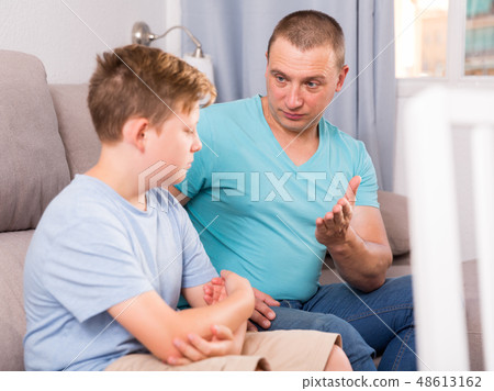 Man with his adult son are serious talking about life together 48613162