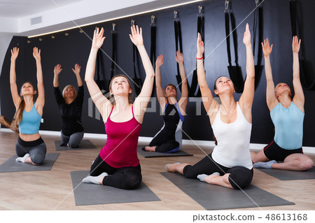 Females exercising during yoga class Females exercising during yoga class 48613168