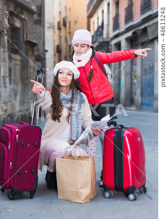 Cheerful girl and woman with map in scarf Cheerful girl and woman with map in scarf 48613248