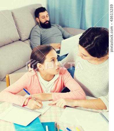 Mother helping daughter with homework Mother helping daughter with homework 48613289