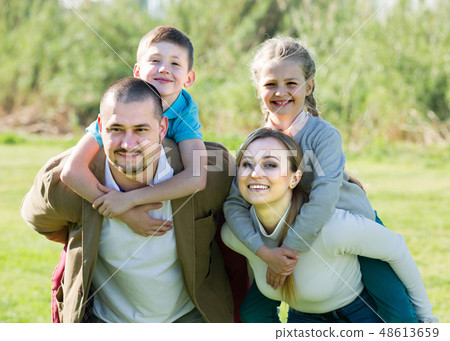 family holding girl and boy 48613659