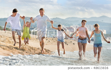 Parents children running on beach 48613816