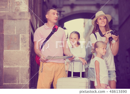 Family with kids walking with camera and map in city 48613890