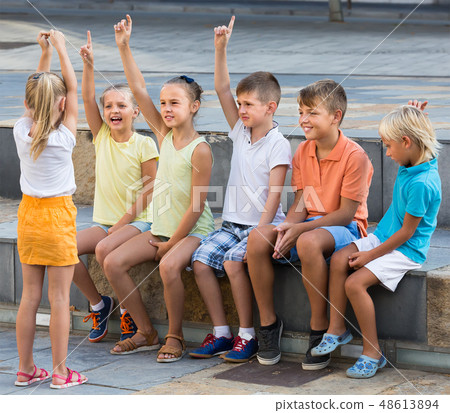 happy kids playing charades outdoors 48613894