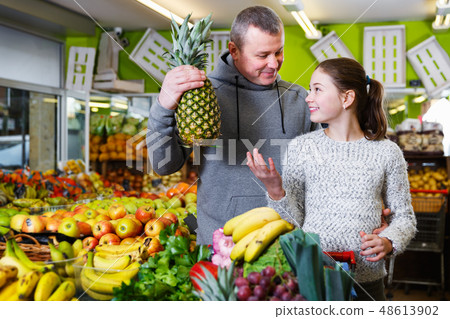 Girl with father in greengrocery 48613902