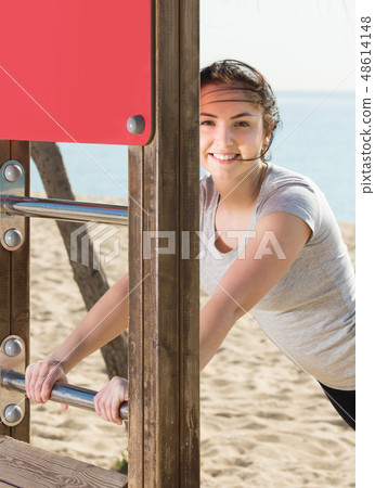 girl doing workout on beach in sunny morning girl doing workout on beach in sunny morning 48614148
