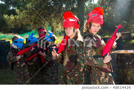 two girls paintball players with marker guns ready for game 48614426