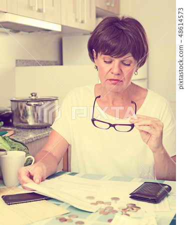 sad woman paying bills sad woman paying bills 48614573
