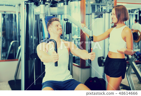 Female assisting man using fly machine Female assisting man using fly machine 48614666