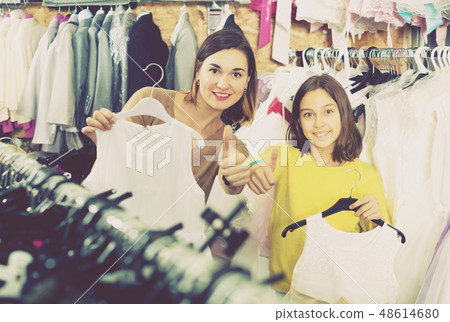 Mother and daughter showing their purchases Mother and daughter showing their purchases 48614680
